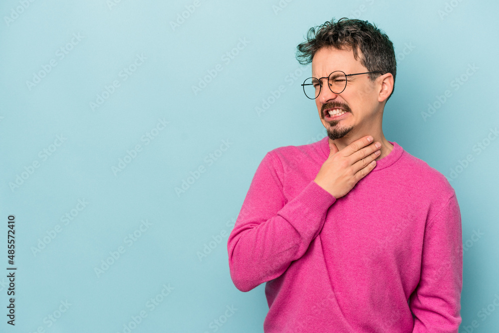Young caucasian man isolated on blue background touching back of head, thinking and making a choice. Young caucasian man isolated on blue background touching back of head, thinking and making a choice.