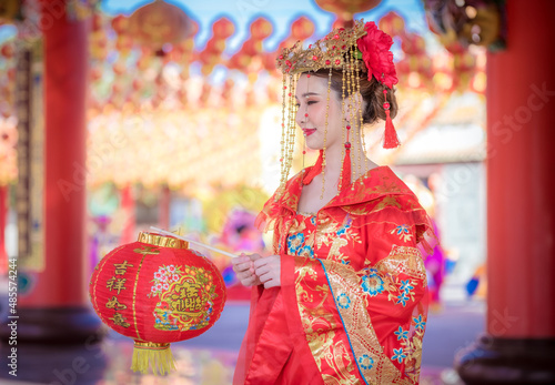 Portrait young beautiful Asian woman wear red cheongsam red.
