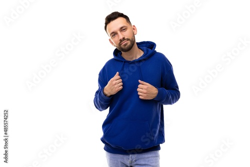 portrait of an attractive middle-aged man in a blue sweatshirt on a white background