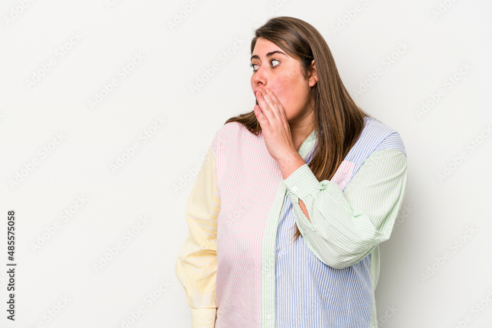Young caucasian overweight woman isolated on white background being shocked because of something she has seen. Young caucasian overweight woman isolated on white background being shocked because of something she has seen.