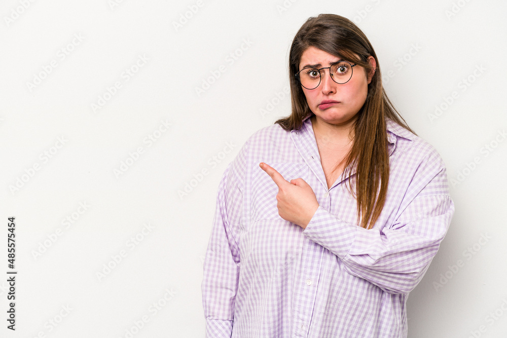 Young caucasian overweight woman isolated on white background smiling and pointing aside, showing something at blank space. Young caucasian overweight woman isolated on white background smiling and pointing aside, showing something at blank space.