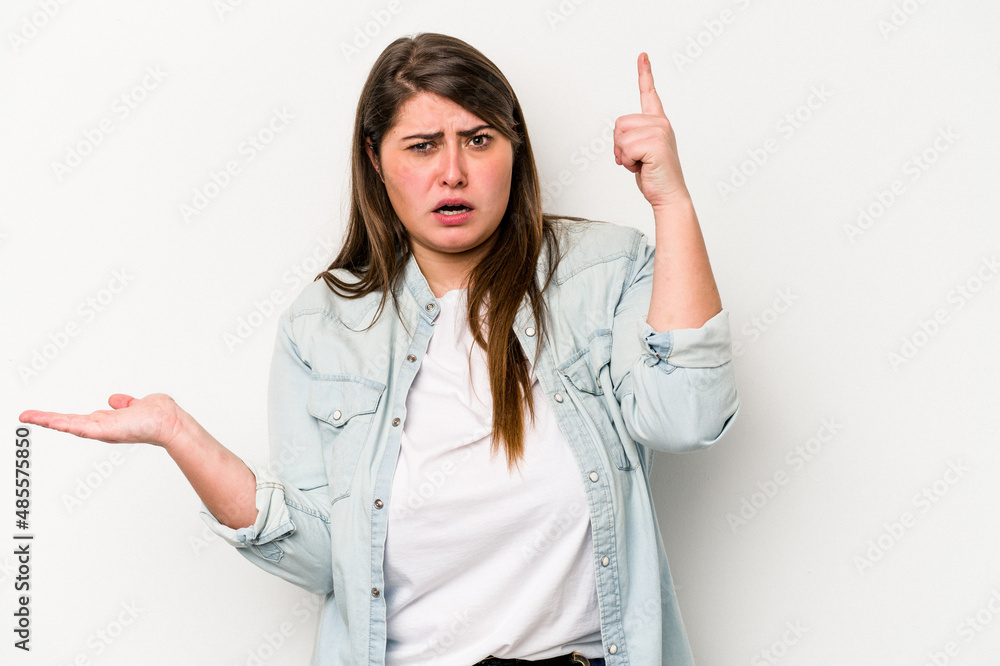 Young caucasian overweight woman isolated on white background holding and showing a product on hand. Young caucasian overweight woman isolated on white background holding and showing a product on hand.