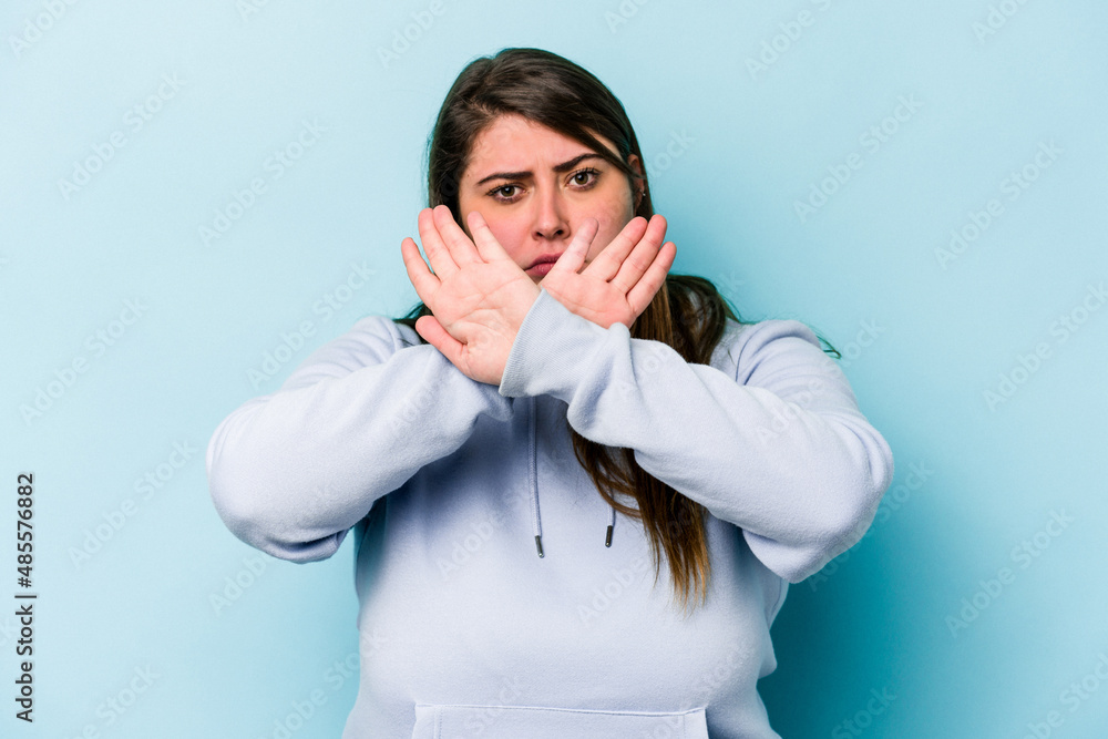 Young caucasian overweight woman isolated on blue background doing a denial gesture Young caucasian overweight woman isolated on blue background doing a denial gesture