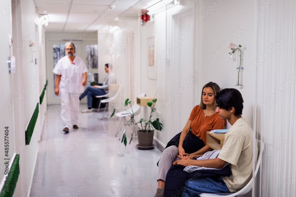 Doctor and patients in hospital corridor Doctor and patients in hospital corridor