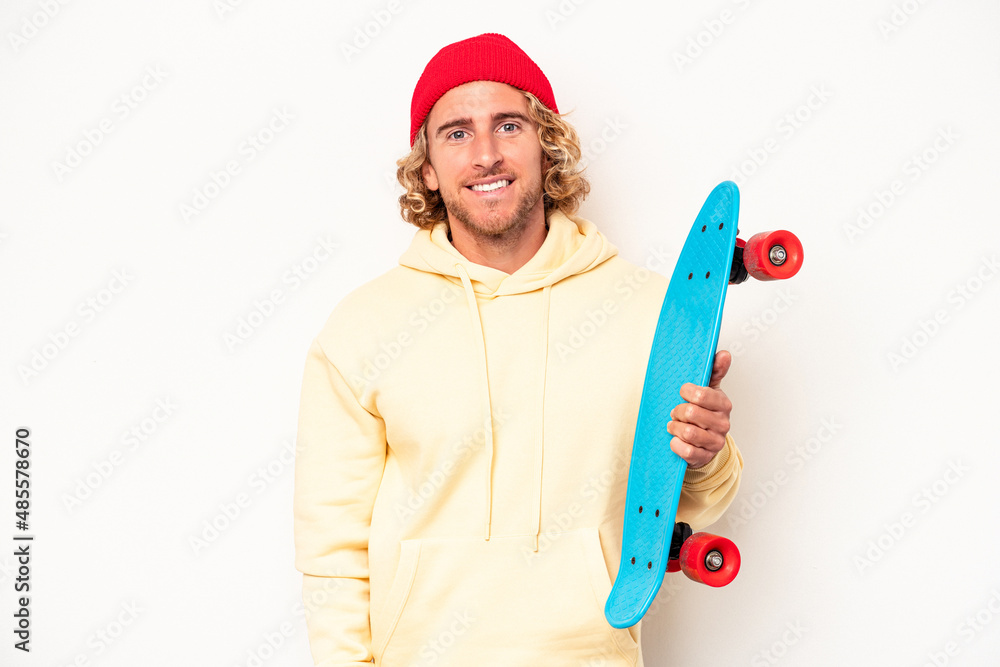 Young skater caucasian man isolated on white background happy, smiling and cheerful. Young skater caucasian man isolated on white background happy, smiling and cheerful.
