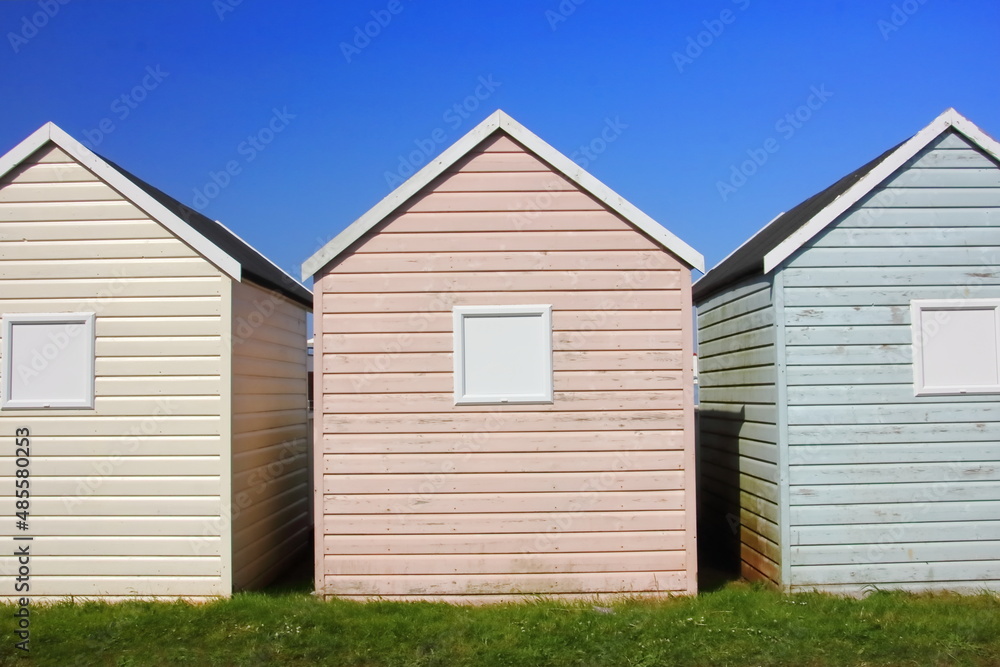 Fototapeta premium Beach huts against summer blue sky