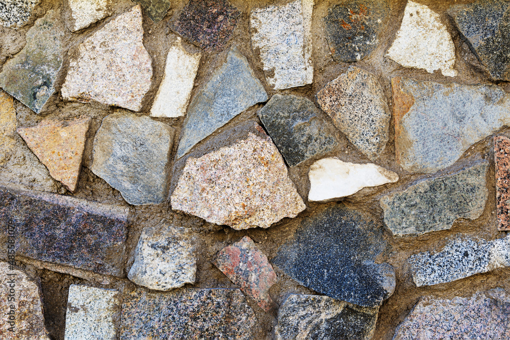 Fototapeta premium Close-up of a fragment of an old natural stone wall