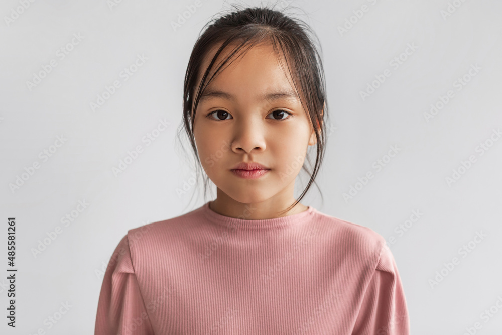 Portrait Of Serious Asian Girl Looking At Camera, Gray Background Portrait Of Serious Asian Girl Looking At Camera, Gray Background