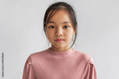 Portrait Of Serious Asian Girl Looking At Camera, Gray Background