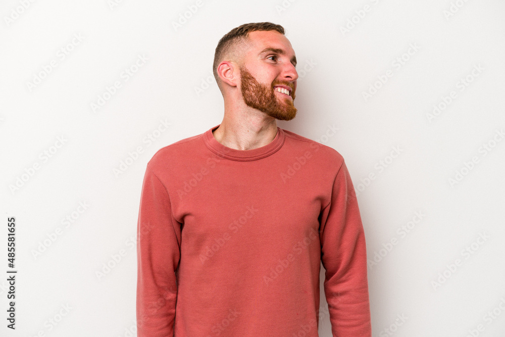 Fototapeta premium Young caucasian man isolated on white background relaxed and happy laughing, neck stretched showing teeth.