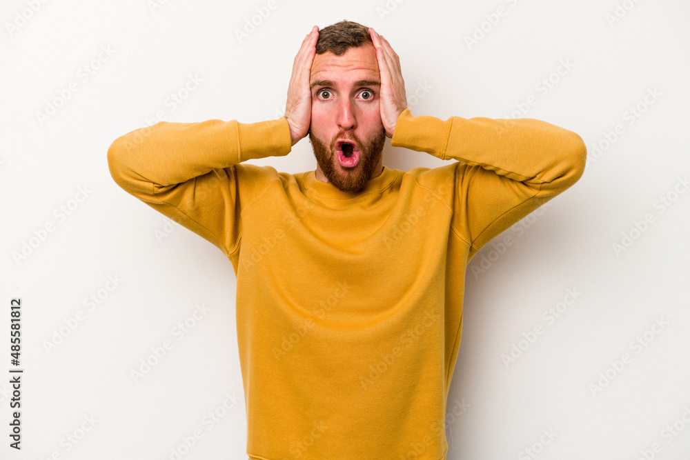 Young caucasian man isolated on white background being shocked, she has remembered important meeting. Young caucasian man isolated on white background being shocked, she has remembered important meeting.
