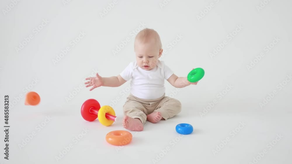 toddler boy playing with a pyramid toy on a white background isolated toddler boy playing with a pyramid toy on a white background isolated