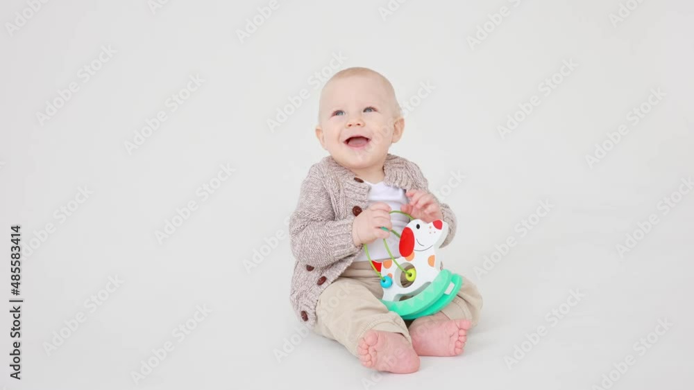 baby boy playing an educational toy on a white background isolated,smiling baby boy playing an educational toy on a white background isolated,smiling