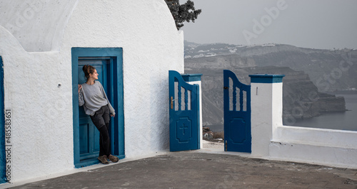 chica riendo frente  a una puerta azul photo