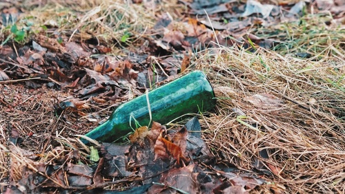 Green Glass Beer Bottle Garbage Dumped on Park Lawn Littering City Public Space