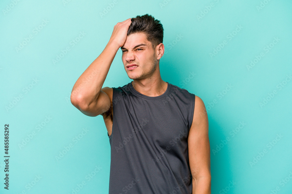 Young caucasian man isolated on blue background forgetting something, slapping forehead with palm and closing eyes. Young caucasian man isolated on blue background forgetting something, slapping forehead with palm and closing eyes.