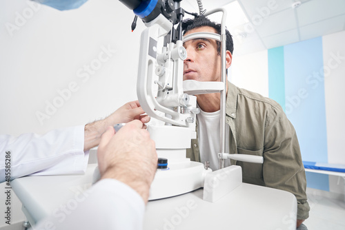 Valokuvatapetti Ophthalmologist using medical equipment, appointment at the hospital