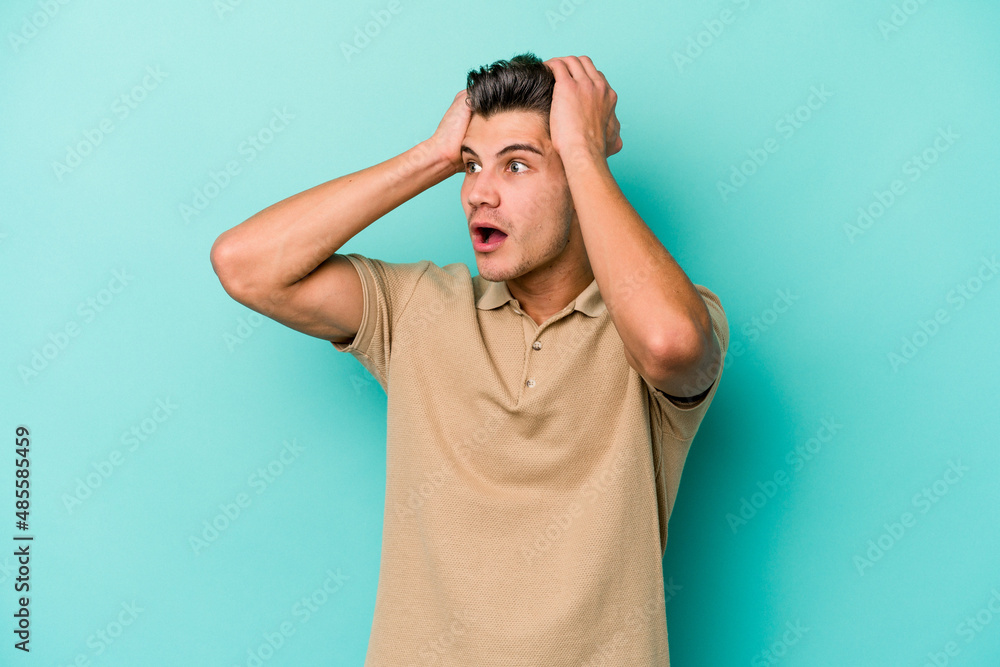 Young caucasian man isolated on blue background screaming, very excited, passionate, satisfied with something. Young caucasian man isolated on blue background screaming, very excited, passionate, satisfied with something.