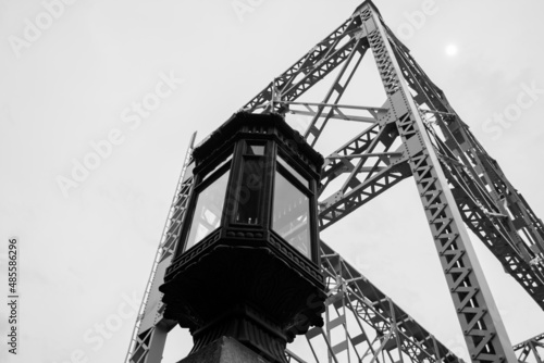 the lamp and bridge tower in the city. Black and white