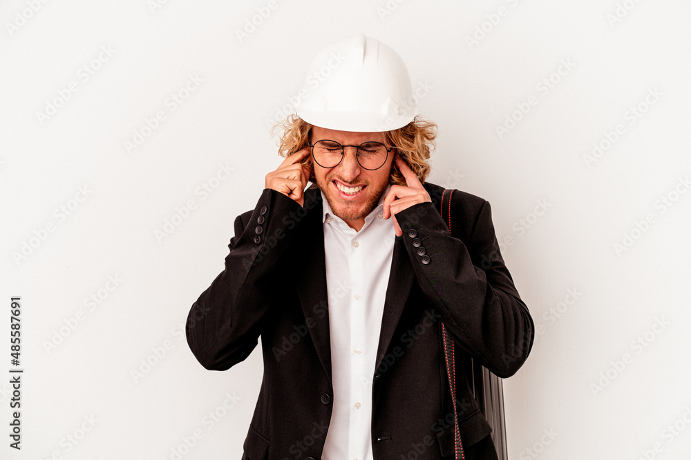 Young architect caucasian man with helmet isolated on white background covering ears with hands. Young architect caucasian man with helmet isolated on white background covering ears with hands.