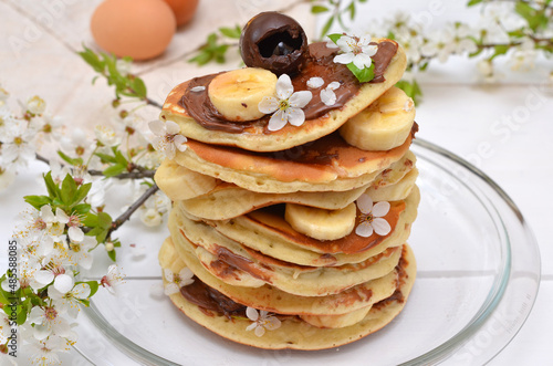 pancakes with chocolate and banana decorated cherry blossom close up