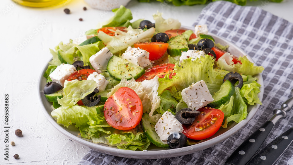 Salad with cherry tomatoes, cucumber, lettuce and cheese. Healthy food concept. Closeup Salad with cherry tomatoes, cucumber, lettuce and cheese. Healthy food concept. Closeup