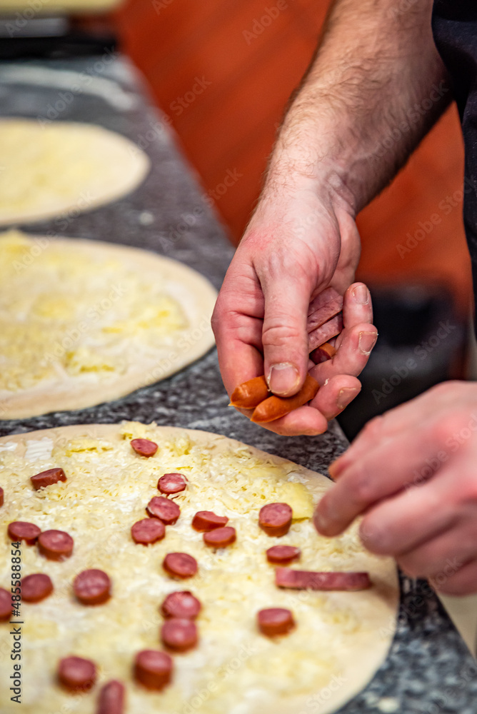 hand of chef baker making pizza at kitchen. The process of making pizza. cooking italian pizza hand of chef baker making pizza at kitchen. The process of making pizza. cooking italian pizza