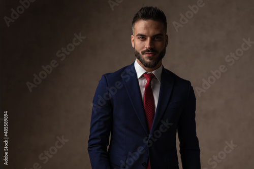 handsome businessman wearing a navy suit with red tie