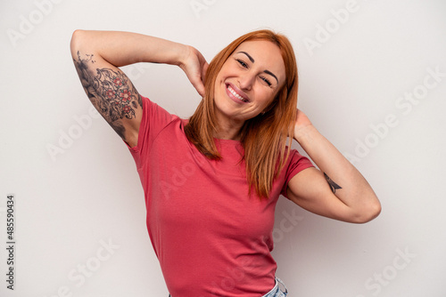 Young caucasian woman isolated on white background stretching arms, relaxed position.