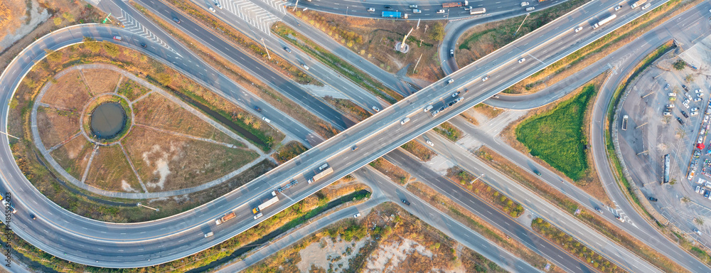 Aerial top view of elevated road and traffic. Modern construction design of traffic ways to avoid traffic jams. Banner panorama background Aerial top view of elevated road and traffic. Modern construction design of traffic ways to avoid traffic jams. Banner panorama background