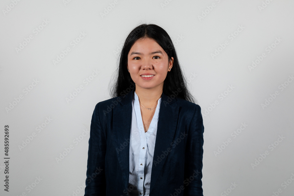 Young woman in a white shirt and black jacket posing on a white background Young woman in a white shirt and black jacket posing on a white background