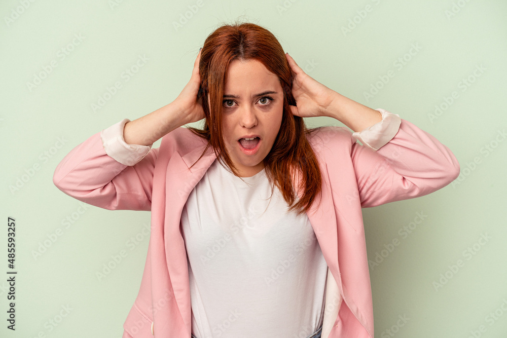 Young caucasian woman isolated on green background screaming, very excited, passionate, satisfied with something. Young caucasian woman isolated on green background screaming, very excited, passionate, satisfied with something.