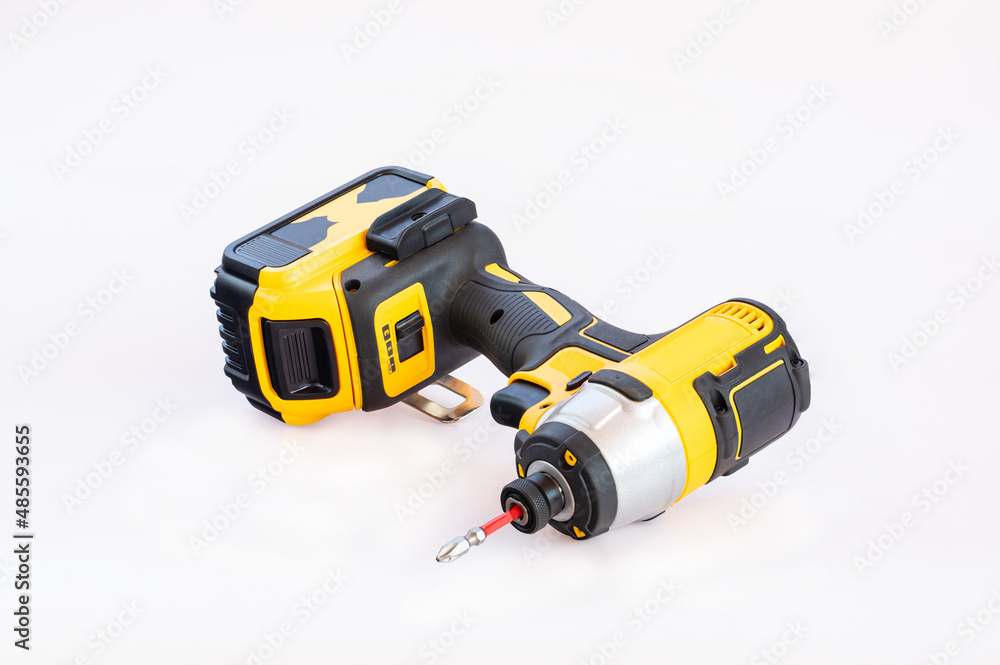 The yellow and black cordless battery powered drill isolated on white background.