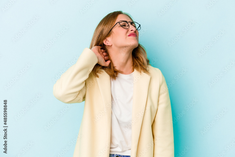 Young caucasian woman isolated on blue background massaging elbow, suffering after a bad movement. Young caucasian woman isolated on blue background massaging elbow, suffering after a bad movement.