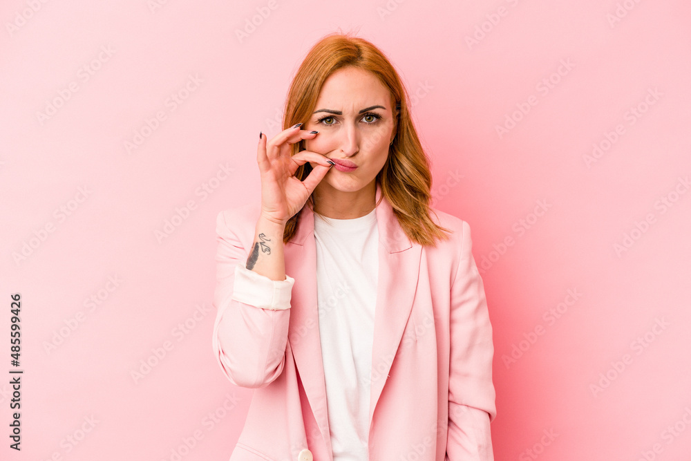 Young caucasian woman isolated on pink background with fingers on lips keeping a secret. Young caucasian woman isolated on pink background with fingers on lips keeping a secret.