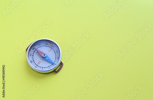 compass on a yellow background. choice concept. journey. business. copy space