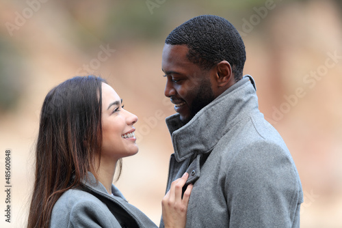 Tablou pe pânză Happy interracial copuple in love flirting looking each other