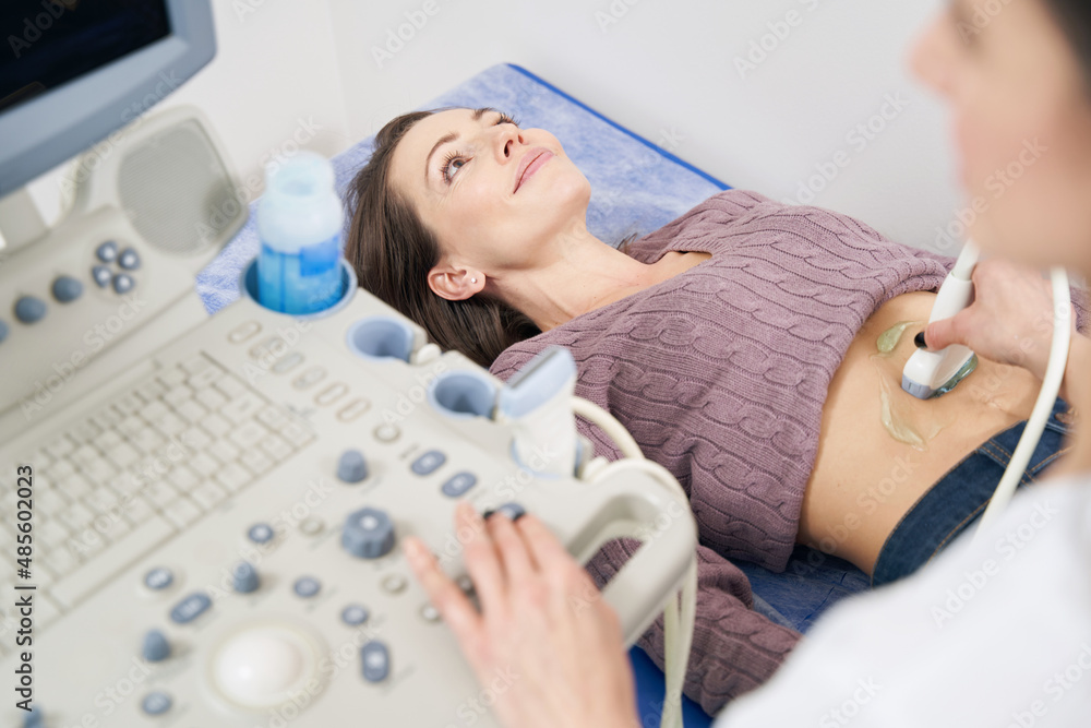 Female patient getting abdominal ultrasonography in clinic Female patient getting abdominal ultrasonography in clinic