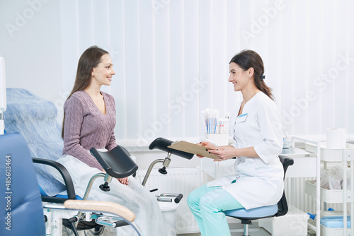 Patient communicating with gynecologist during private medical consultation photo