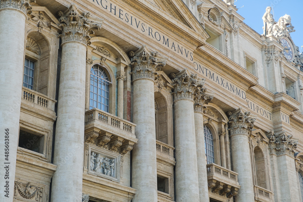 Low angle view of exterior and entrance of Saint Peter's Basilica.