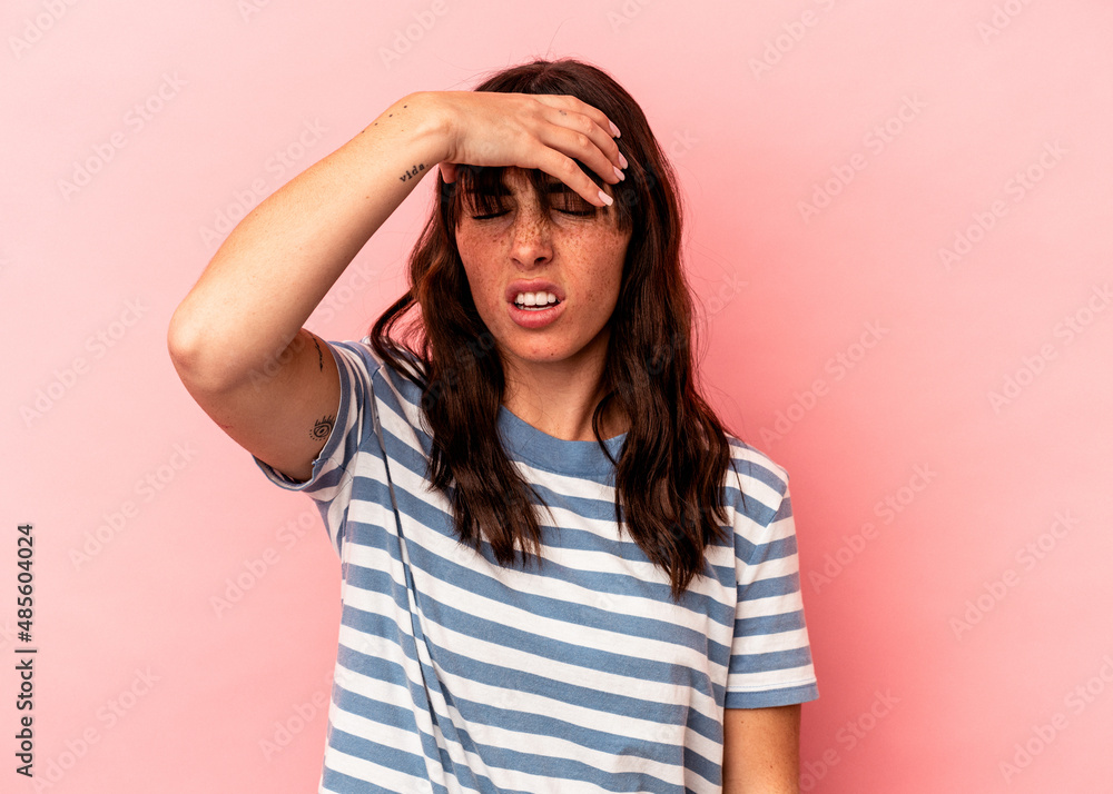 Young Argentinian woman isolated on pink background touching temples and having headache. Young Argentinian woman isolated on pink background touching temples and having headache.