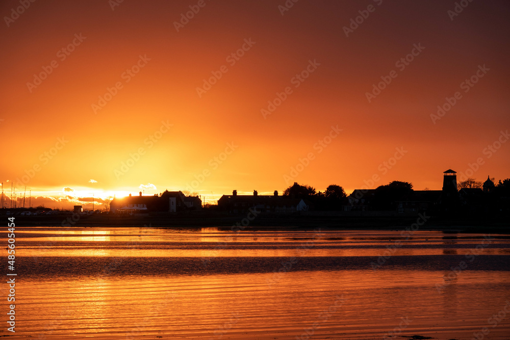 vibrant orange sunset over the sea at Langstone Harbour England