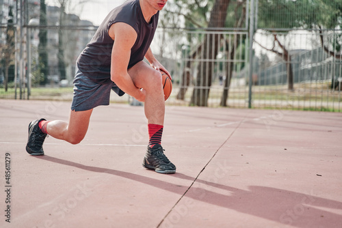 Banner of a sportsman with a basketball on a neighborhood court practicing dribbling.