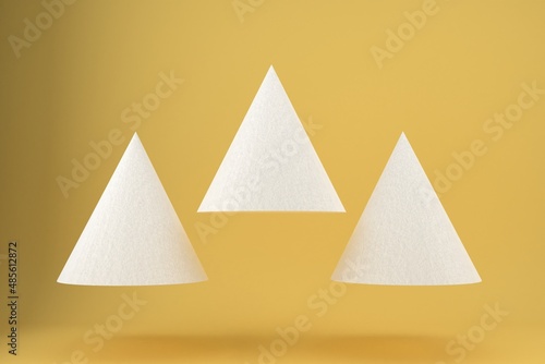 Three white triangles with paper texture on a yellow background