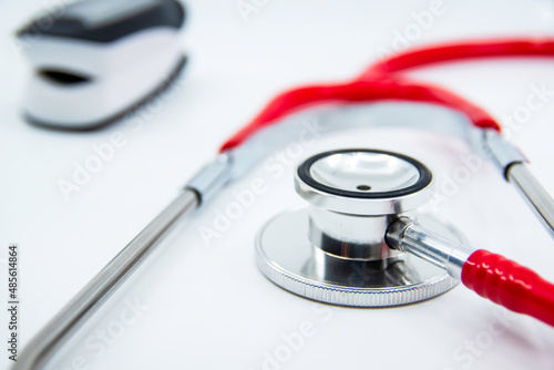 Stethoscope and Pulse Oximeter isolated on white background. Pulse Rate Health Tester is used to measure air in lungs. Covid-19, healthcare concept.