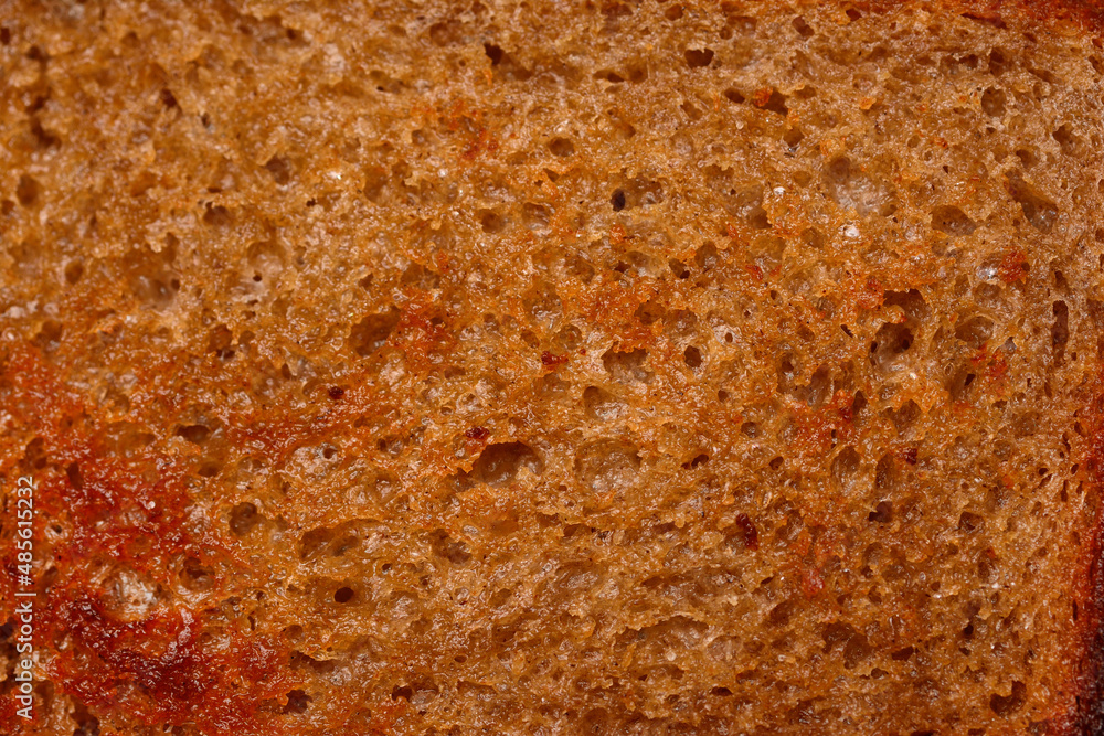 The surface of bread fried in butter with a crispy crust. Close-up texture