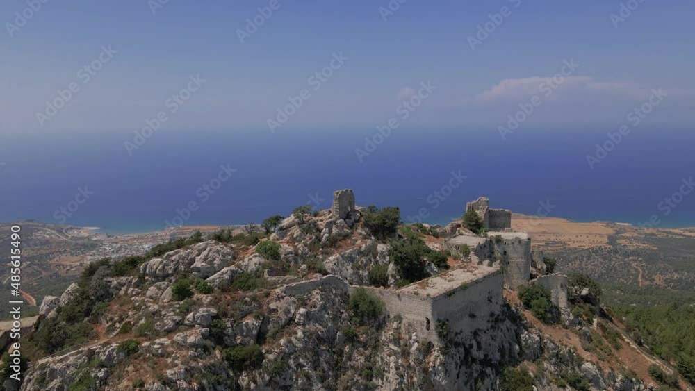 Aerial 4K landscape view of medieval Kantara Castle which is located at the Mountains in North Cyprus. Medieval Castle is surrounded with rocks & trees with an amazing view of Mediterranean Sea. Aerial 4K landscape view of medieval Kantara Castle which is located at the Mountains in North Cyprus. Medieval Castle is surrounded with rocks & trees with an amazing view of Mediterranean Sea.
