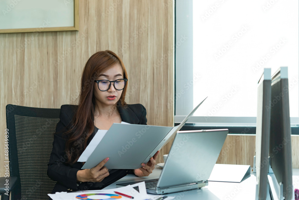 Beautiful asian woman working at the office  in the evening,Thailand worker work overtime for company,A businesswoman think