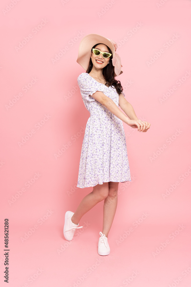 Happy Asian woman traveler standing isolated on pink background, Tourist girl having cheerful holiday trip concept, Full body composition Happy Asian woman traveler standing isolated on pink background, Tourist girl having cheerful holiday trip concept, Full body composition