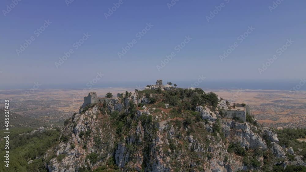 Aerial 4K landscape view of medieval Kantara Castle which is located at the Mountains in North Cyprus. Medieval Castle is surrounded with rocks & trees with an amazing view of Mediterranean Sea. Aerial 4K landscape view of medieval Kantara Castle which is located at the Mountains in North Cyprus. Medieval Castle is surrounded with rocks & trees with an amazing view of Mediterranean Sea.
